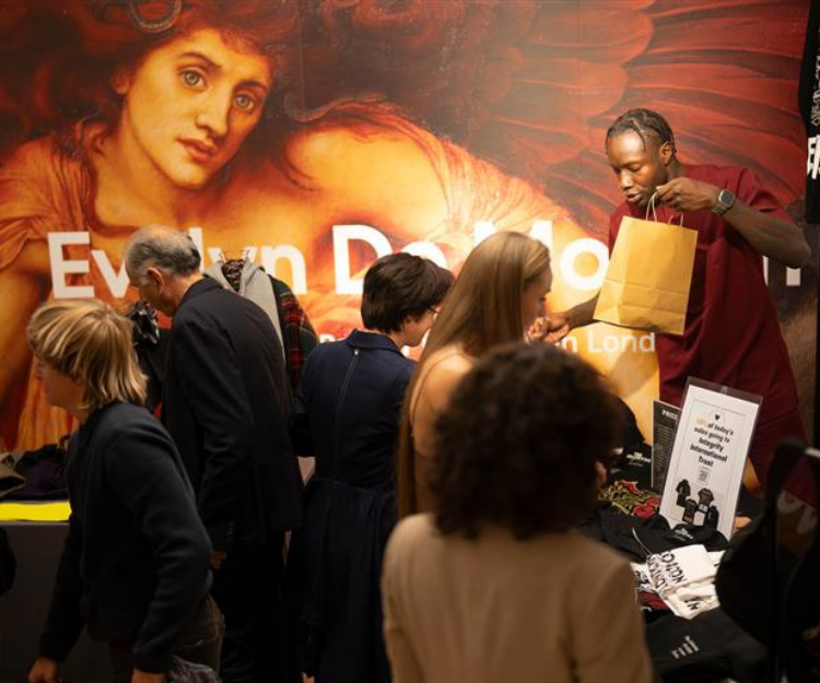 Attendees gather around a painting displayed on an easel inside Guildhall Art Gallery during Fashion Frenzee by Central London Alliance, part of London Fashion Week
